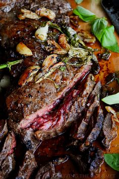 the steak has been cooked and garnished with green leaves on it's side