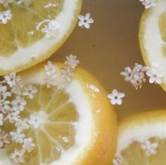 four lemons with white flowers on them