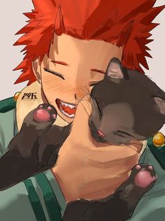 a person holding a black cat with red hair