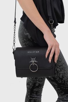 AZAZELE.- Textured PU bag.- Baphomet hardware detail.- Fully lined.- Inner pockets.- Adjustable, detachable straps.- Width 20.5cm / 8.1"- Height 16cm / 6.3"With KILLSTAR branding, 100% Polyurethane (Excluding Trims).Wipe clean with a damp cloth only. Imported. Gothic Black Bags With Metal Hardware, Edgy Shoulder Bag With Hardware Details, Black Shoulder Satchel With Hardware, Edgy Shoulder Bag With Gunmetal Hardware For Daily Use, Edgy Crossbody Bags For Travel, Edgy Crossbody Bag With Hardware Details, Edgy Shoulder Bag With Adjustable Strap For Daily Use, Rectangular Shoulder Bag With Hardware, Daily Use Shoulder Bag With Hardware Details