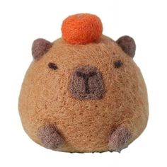 a small stuffed animal with an orange on top of it's head and ears