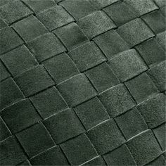 a black and white photo of an area rug with squares on the top, in shades of green