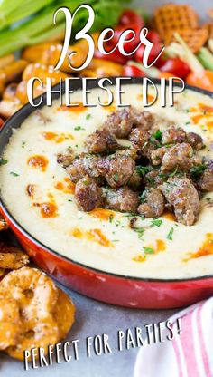 a red bowl filled with cheese dip and meatballs