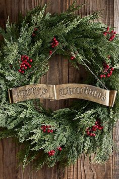 a christmas wreath hanging on a wooden wall