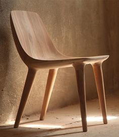 a wooden chair sitting on top of a white floor next to a wall and window