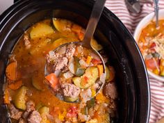 a spoon full of soup with meat and vegetables