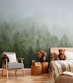 there is a teddy bear sitting on the bed in this room with trees behind it