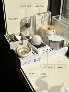 an assortment of items displayed on display in front of a window sill with labels describing the contents