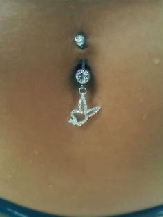 a woman's belly is adorned with an anchor and a diamond