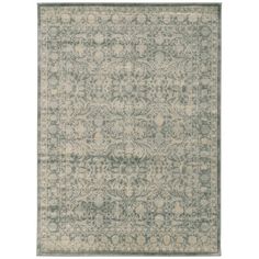 a rug with an ornate design in grey and white colors on the floor, it has a light green border