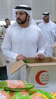 a man standing next to a box filled with food