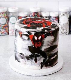 a spiderman themed cake with sprinkles on it