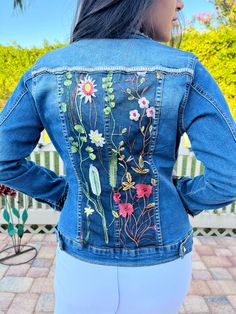 Ornate, stylish and comfortable blue or black denim jacket with overlay of intricate flowered lace design that is sewed strategically onto the jacket. Studs are applied to add style and brilliance. There is an option for rhinestone fringes.  And this is handmade, unique and one of a kind!  Express yourself with one of these fashionable jackets that will be custom designed for you!  Made with love and to bring out the beauty you have inside! Fitted Floral Print Denim Jacket, Bohemian Dark Wash Denim Jacket For Spring, Fitted Embellished Medium Wash Denim Jacket, Fitted Denim Outerwear With Floral Embroidery, Fitted Bohemian Denim Blue Denim Jacket, Fitted Bohemian Denim Jacket In Blue, Bohemian Fitted Denim Blue Jacket, Fitted Blue Denim Jacket With Floral Embroidery, Fitted Denim Jacket With Floral Print