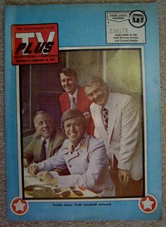 a group of men sitting at a table in front of a tv advertisement for t v