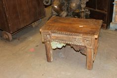 an old wooden table with carvings on it