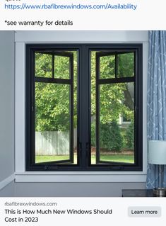 an open window in a room with blue curtains