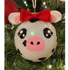 a christmas ornament with a pig face on it