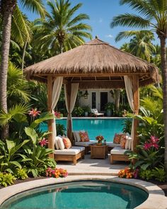 an outdoor gazebo next to a swimming pool surrounded by palm trees and flowers with chairs around it