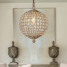 a chandelier hanging over a fireplace in a living room