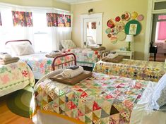 two beds in a room with quilts on them