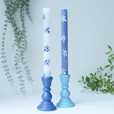 two blue candles sitting next to each other