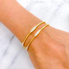 This exquisite 18k gold bangle, weighing 9.96 grams, features a modern and lightweight design adorned with dazzling diamonds. The yellow gold finish enhances its elegant appeal, making it perfect for any occasion. The bangle is set with 0.75 carats of G-H color, VVS-VS quality diamonds in round brilliant cut shapes. With a bangle size of 2.4 and an opening diameter of 2.25 inches, this piece offers both style and comfort. Ideal for those who appreciate high-quality craftsmanship and contemporary Single Bangle, 18k Gold Bangle, Yellow Gold Bangle, Gold Bangle, Diamond Bangle, Diamond Gold, Quality Diamonds, Round Brilliant Cut Diamond, Gold Bangles