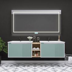 a bathroom vanity with two sinks and a large mirror above it, next to a potted plant