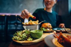 a person sitting at a table with food in front of them