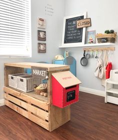 a wooden crate with some food inside of it on the floor in front of a window