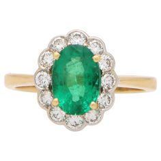 A beautiful emerald and diamond cluster ring set in 18k yellow and white gold. The piece is centrally set with a vibrant oval cut emerald which is claw set in yellow gold. The emerald has a fantastic vibrant green colour to it and is surrounded by a cluster of 12 round brilliant cut diamonds; all of which are encased in a white gold setting. Once worn the piece truly comes to life. Due to the oval shaped emerald the ring elongates the wearers finger which is not only a slimming look but also loo Cluster Ring Set, Emerald Cut Diamond Engagement, White Gold Set, Engagement Ring Diamond Cut, Gold Band Ring, Modern Necklaces, Art Deco Engagement Ring, Emerald Engagement Ring, Diamond Drop Earrings