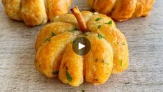 several small pumpkin shaped pastries sitting on top of a table