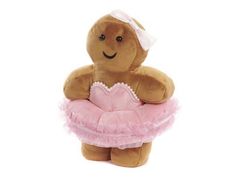 a stuffed teddy bear wearing a pink dress