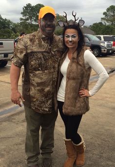 a man and woman dressed up as deer antlers