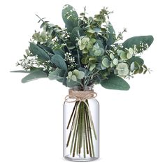 a glass vase filled with lots of green flowers and greenery on top of a white background