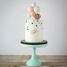 a birthday cake with balloons on top