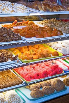 a display case filled with lots of different types of doughnuts and pastries