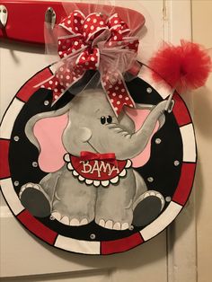 a red and white door hanger with an elephant on it