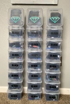 several plastic storage containers with different types of jewelry in them