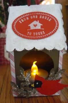 a small box with a candle inside on a table