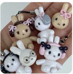 a person is holding some cute little keychains in their hand and it looks like they are wearing bunny ears