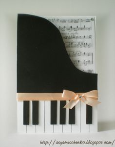 a black and white piano with a bow on it