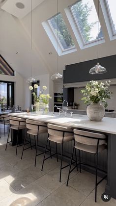 a large kitchen with an island and skylights