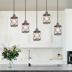 a bunch of lights hanging from the ceiling in a kitchen