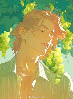 a young man standing under a bunch of green grapes