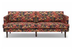 an upholstered floral couch with wooden legs and arm rests against a white background