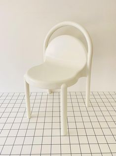 a white chair sitting on top of a tiled floor