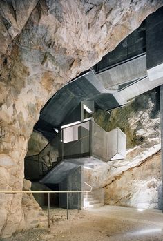 the inside of a cave with stairs leading up to it