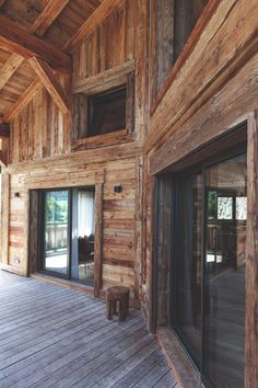 the inside of a wooden house with sliding glass doors