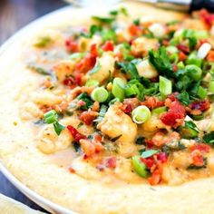 a tortilla topped with shrimp and green onions