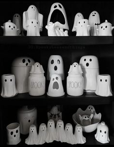 black and white photograph of halloween decorations on shelves with ghost faces in the bottom right corner